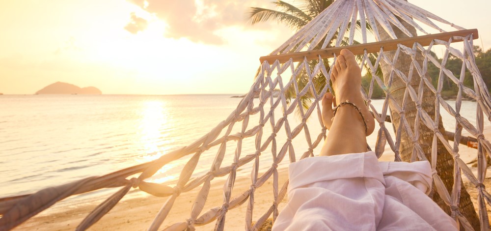 woman’s feet on a hammock at the beach | how to make your compliance audits easier