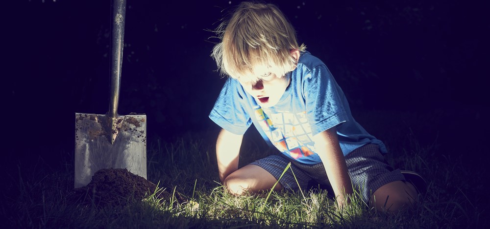boy digging up treasure at night | deliver value to auditing clients