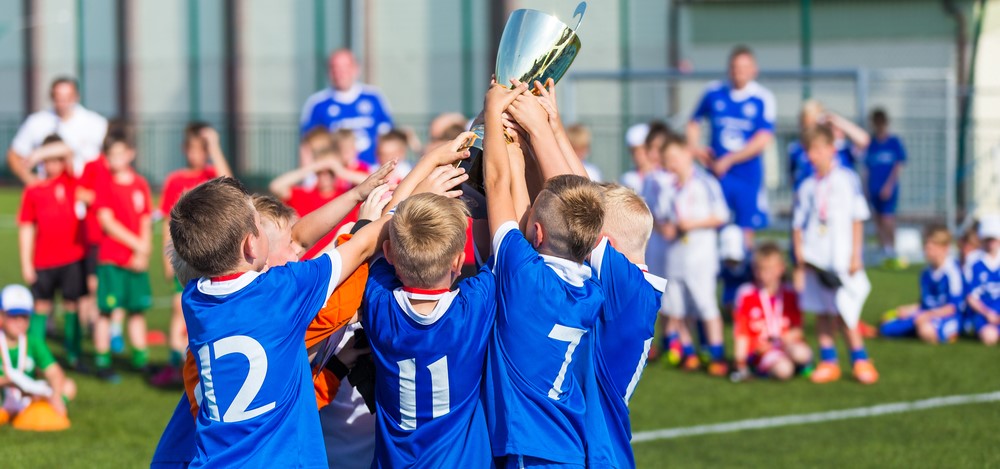 kids soccer team celebrating a win | compliance and auditing as a team sport