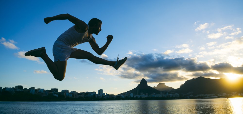 Silhouette of athlete jumping in front of a lake | agile internal audit teams