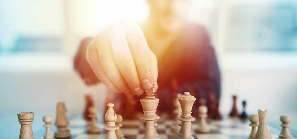 man moving a chess piece | control your compliance data