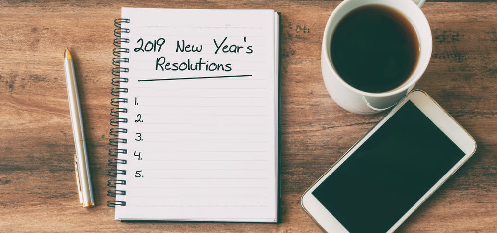 2019 New Year’s Resolutions on a notepad, with coffee and smartphone | end compliance chaos in 2019