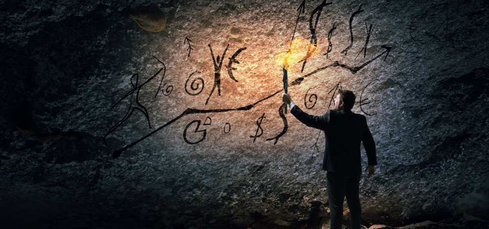 businessman writing on a cave wall