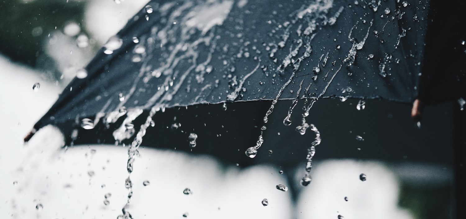 black umbrella in a rainstorm | cyber liability insurance protection