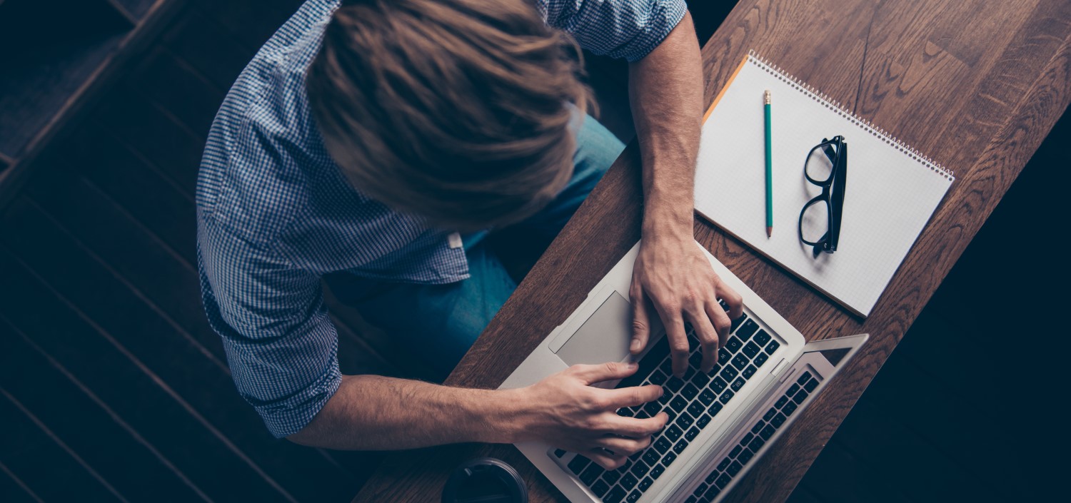 top view of man at his laptop computer | how secure is TCT’s customer data?