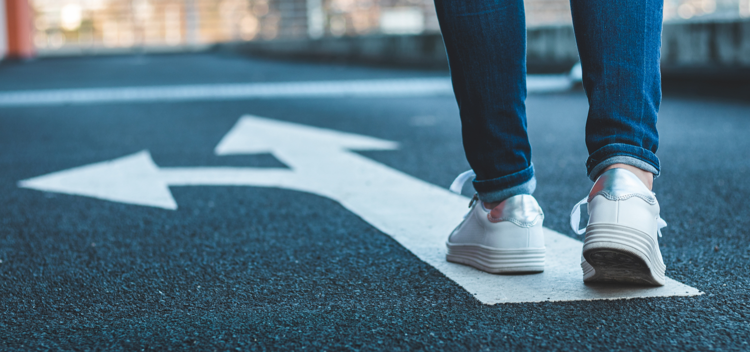 Walking on a directional arrow sign painted on the road | compliance unfiltered podcast consultants vs. assessors