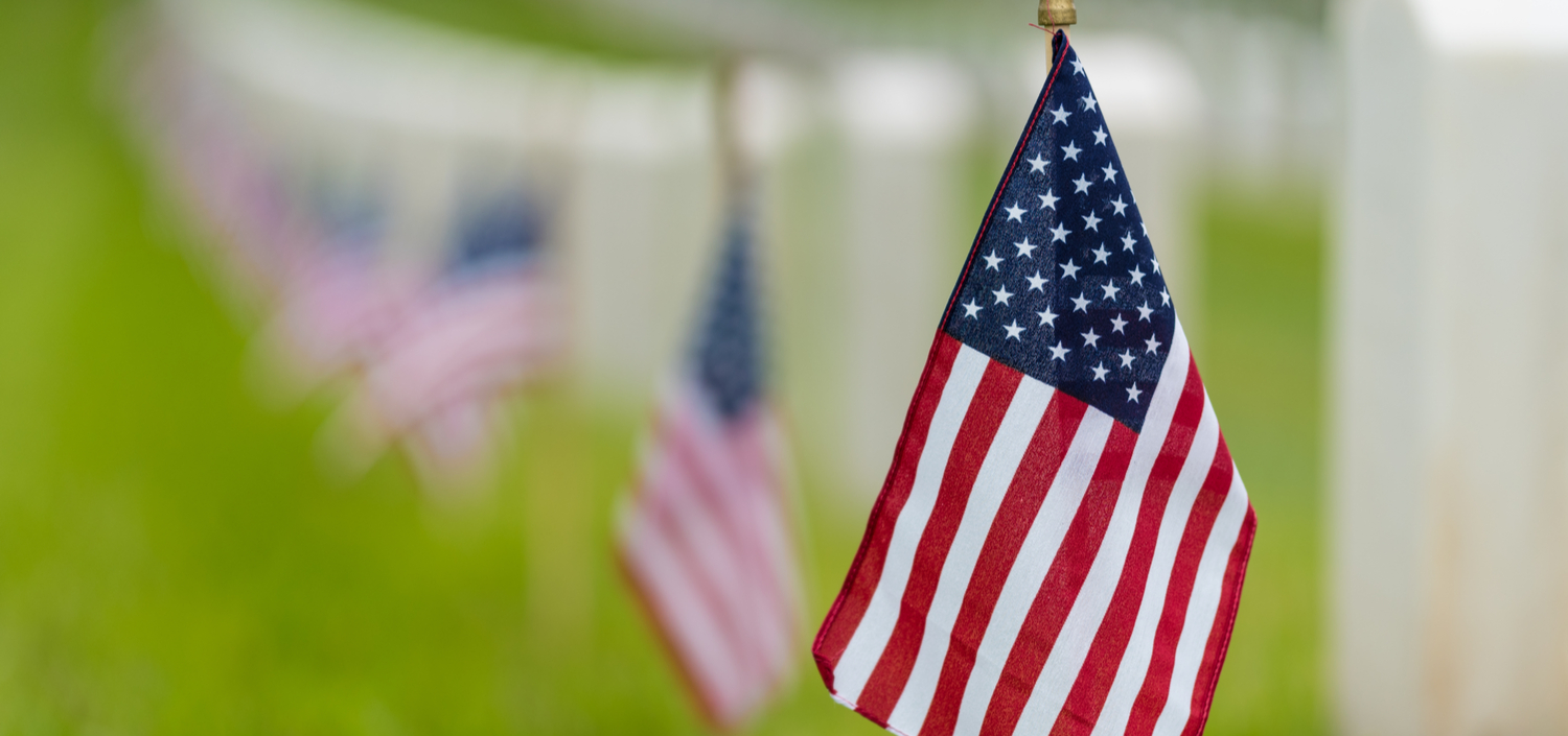 small American flags planted by veterans’ graves for Memorial Day