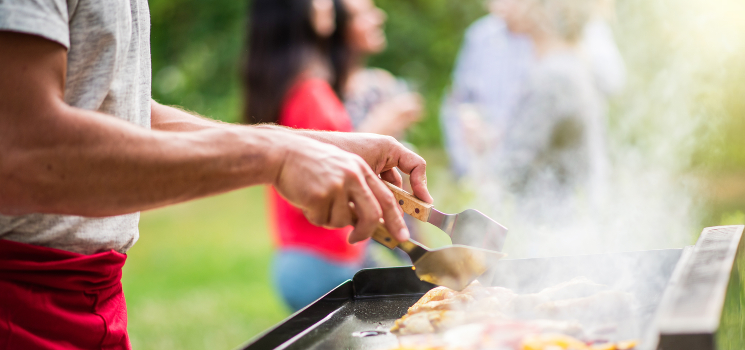 family having a backyard barbeque | Labor Day for compliance professionals