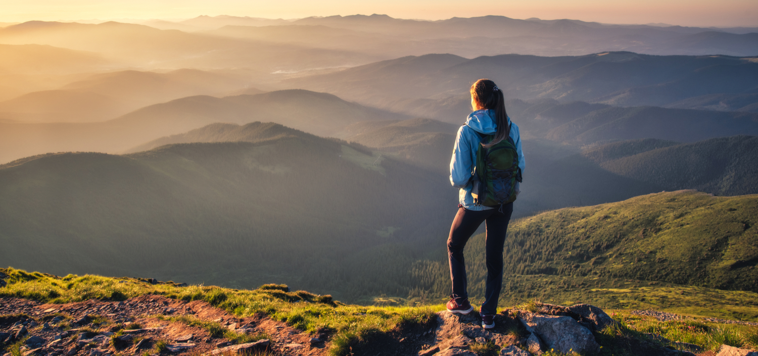 female hiker on a mountain peak | Live Linking for multiple compliance standards