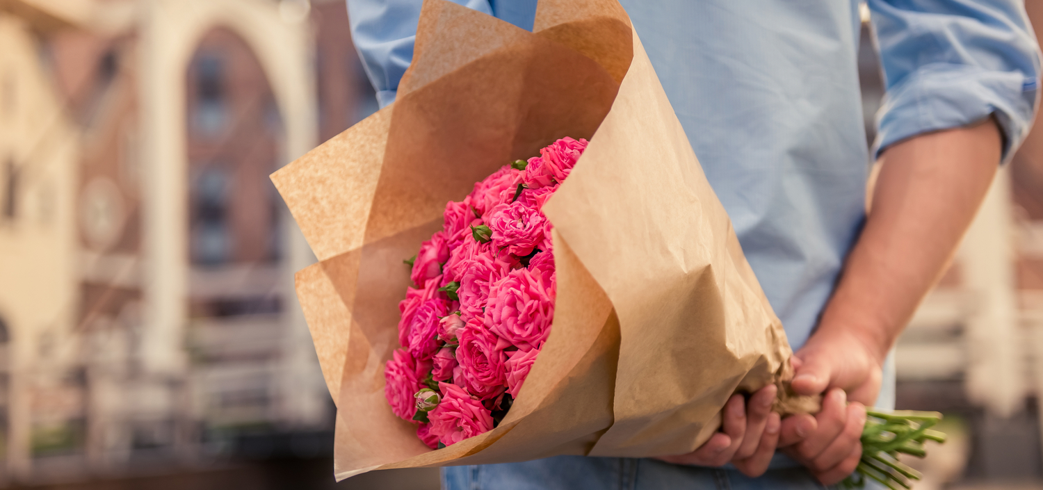 man with bouquet of flowers behind his back | compliance Assessor relationship