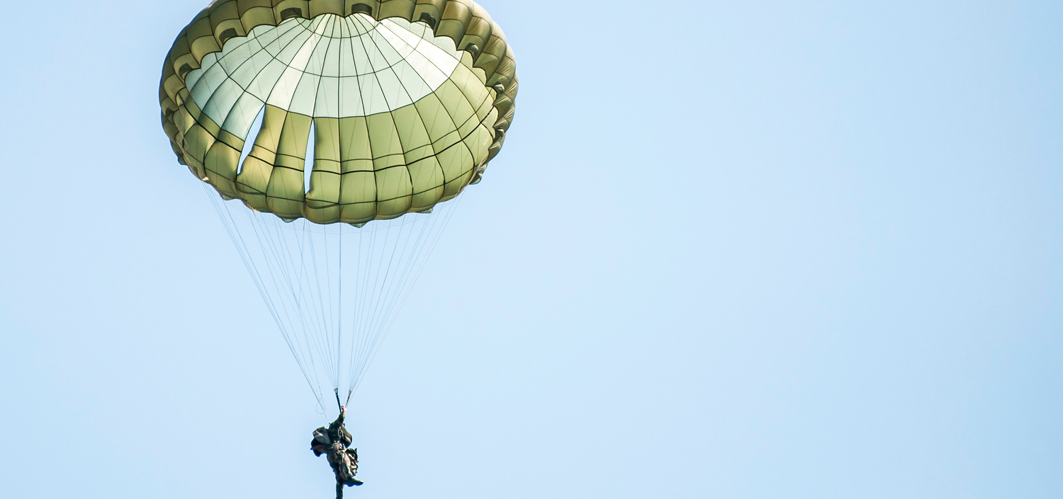 parachutist against a blue sky | cyber liability insurance