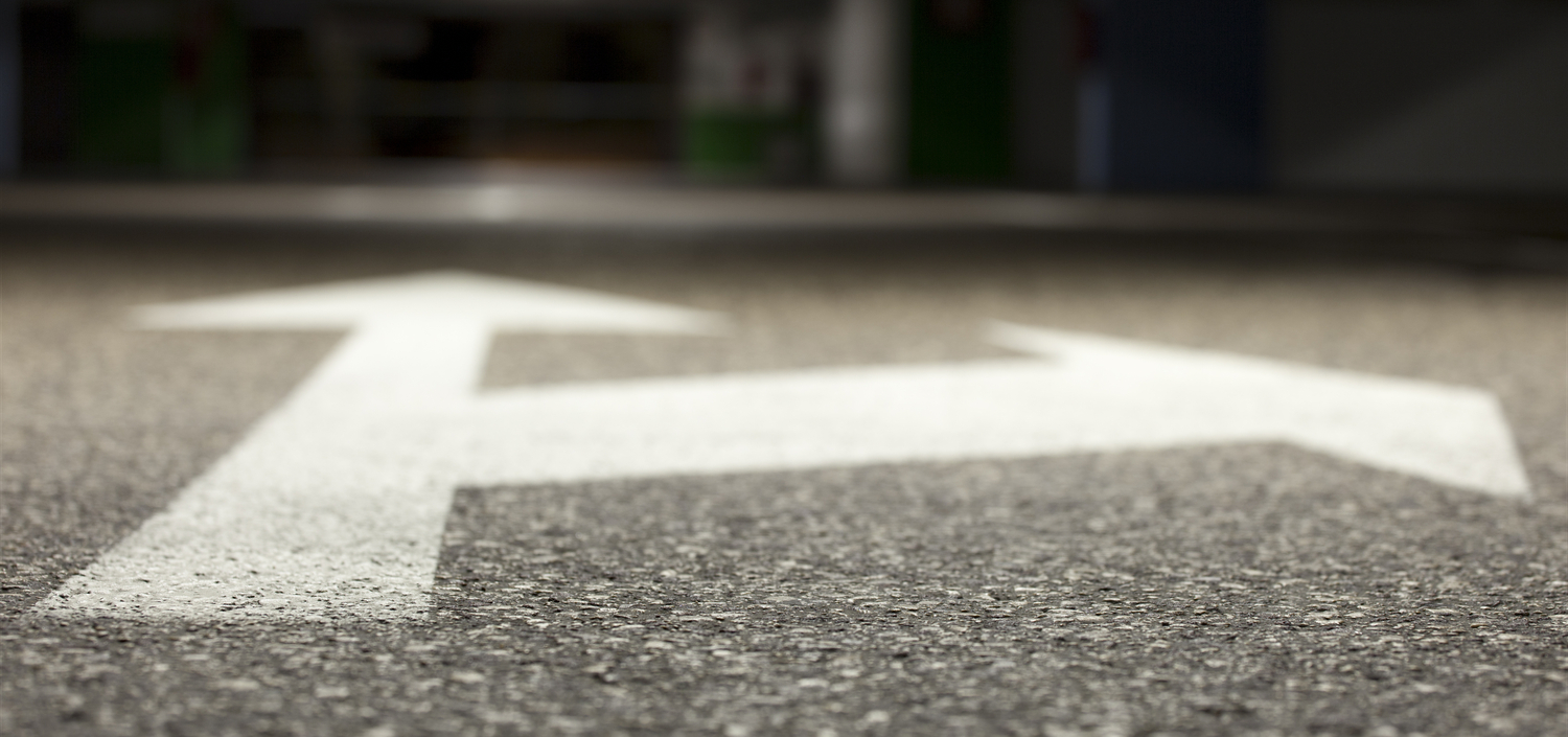 closeup of bidirectional arrows painted on the road | business benefits of cybersecurity