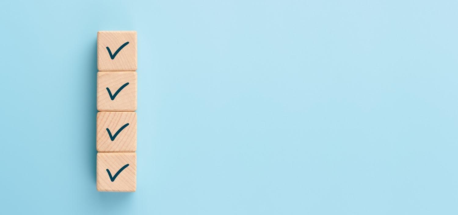 Check mark on wooden blocks, blue background | trust but verify