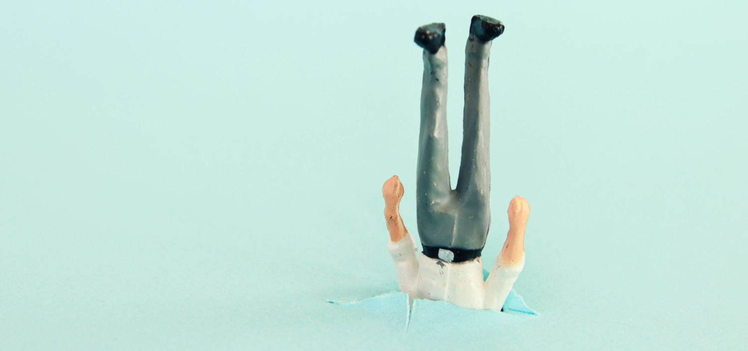 Plastic figurine of a businessman stuck upside down | are you making these common compliance management mistakes