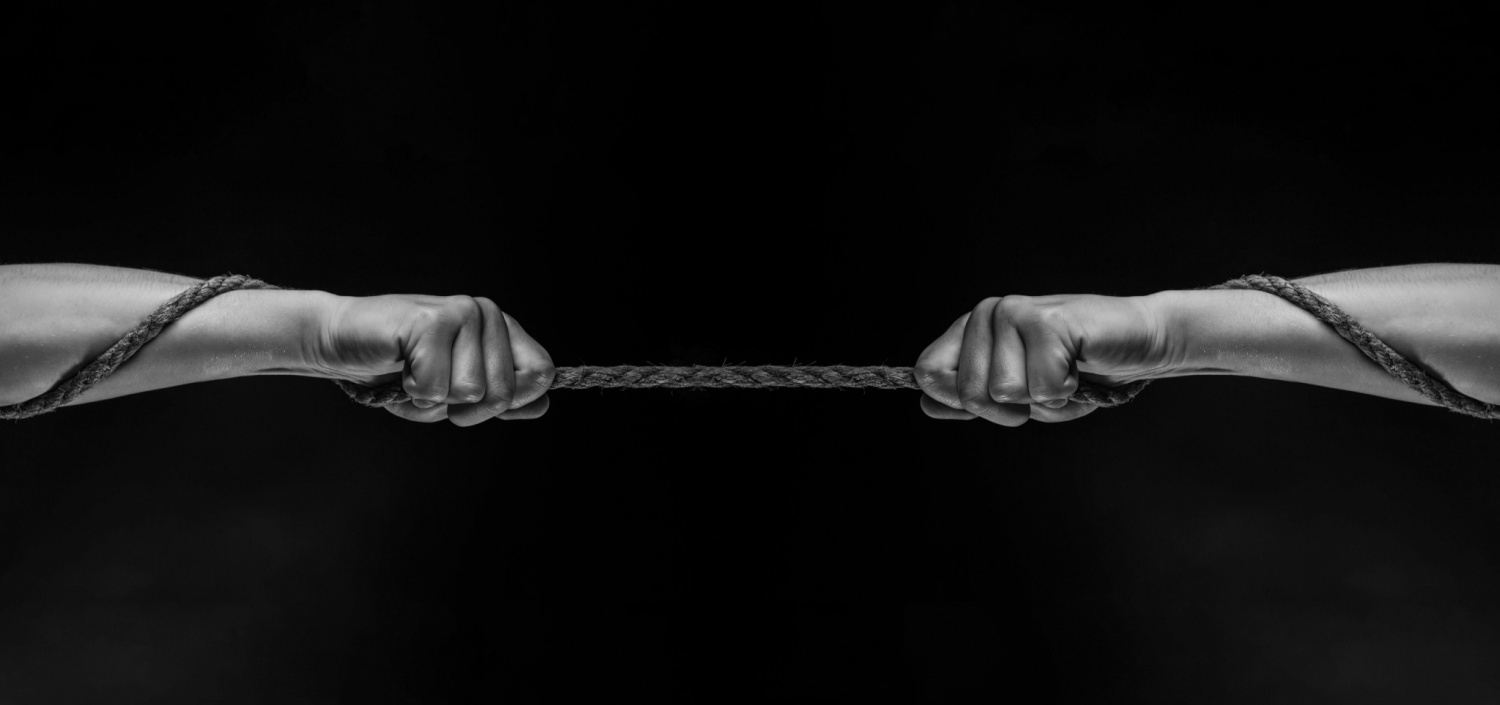 black and white image of a tug-of-war | resistance to compliance