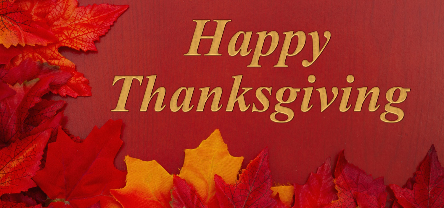Leaves with the words “Happy Thanksgiving” on red background
