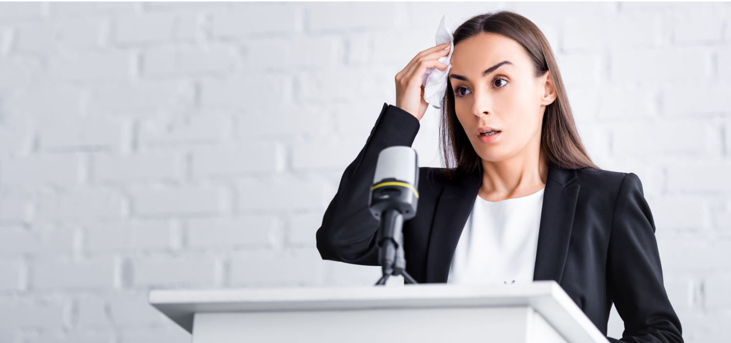 Nervous business woman in front of a microphone | communicating data breach