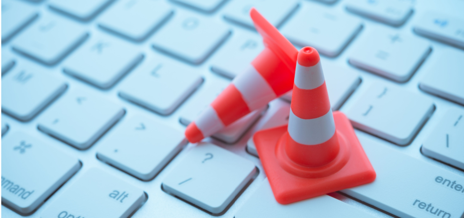 mini traffic cones on a computer keyboard | CMMC maintenance