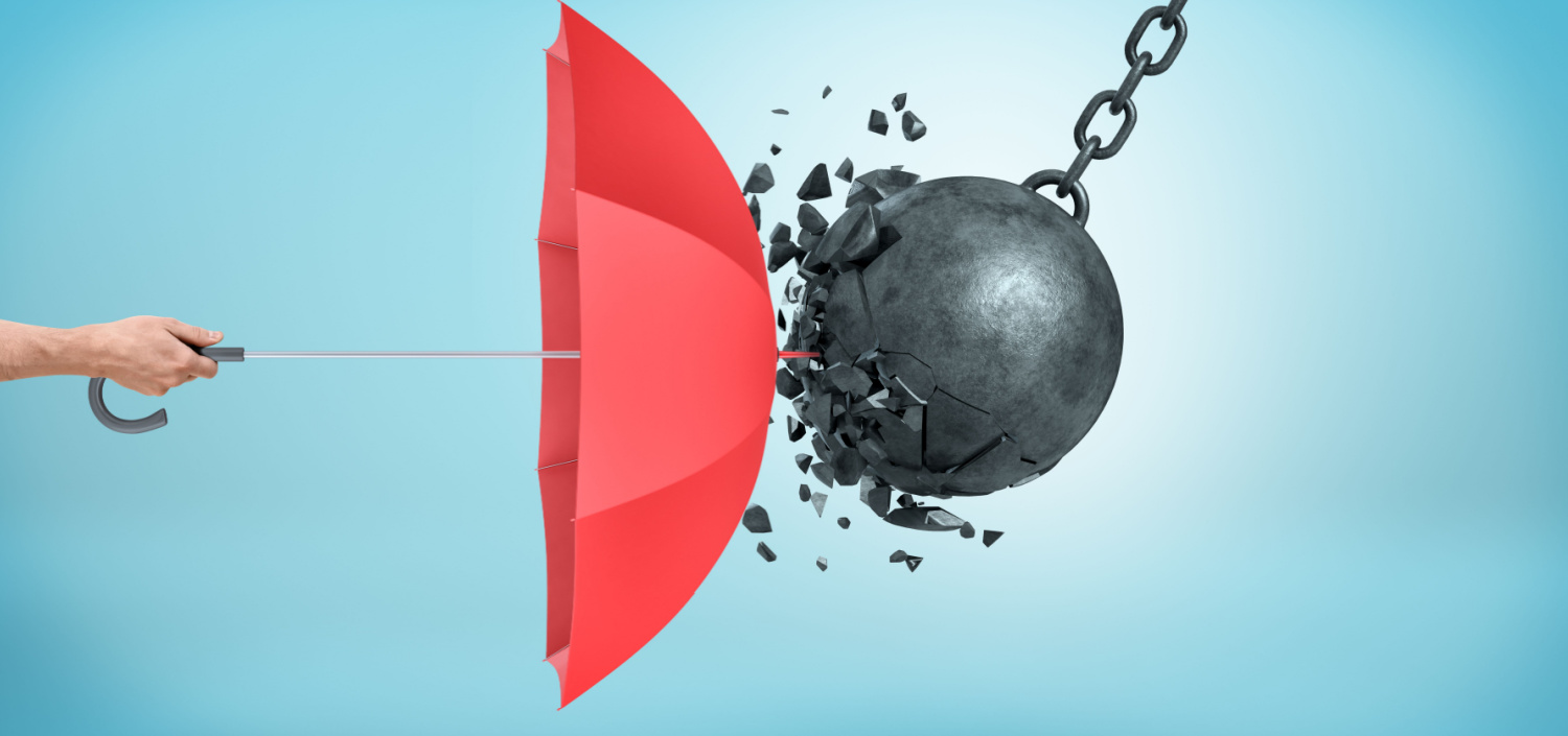 red umbrella acting as a shield against a wrecking ball | ransomware attack