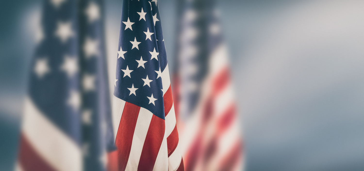 Closeup of American flags | TCT Portal independence from manual compliance management