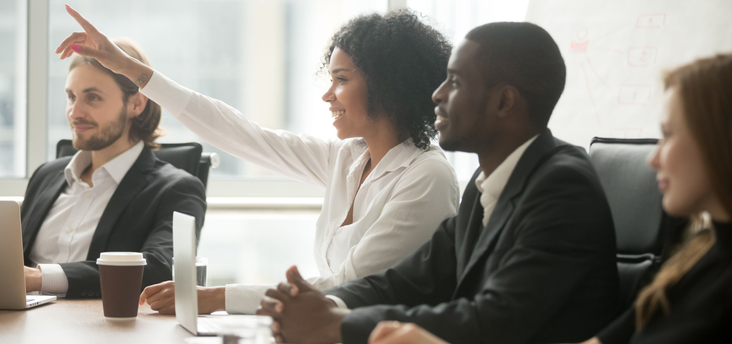 woman raising her hand in a PCI DSS training session