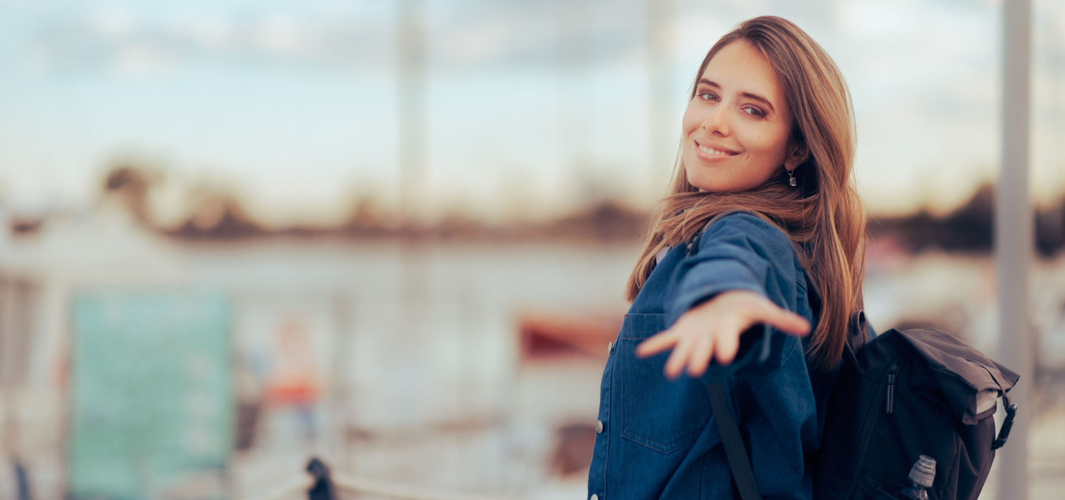 young woman with a traveling backpack looking at the camera | Join TCT at the PCI Conference in North America and Europe