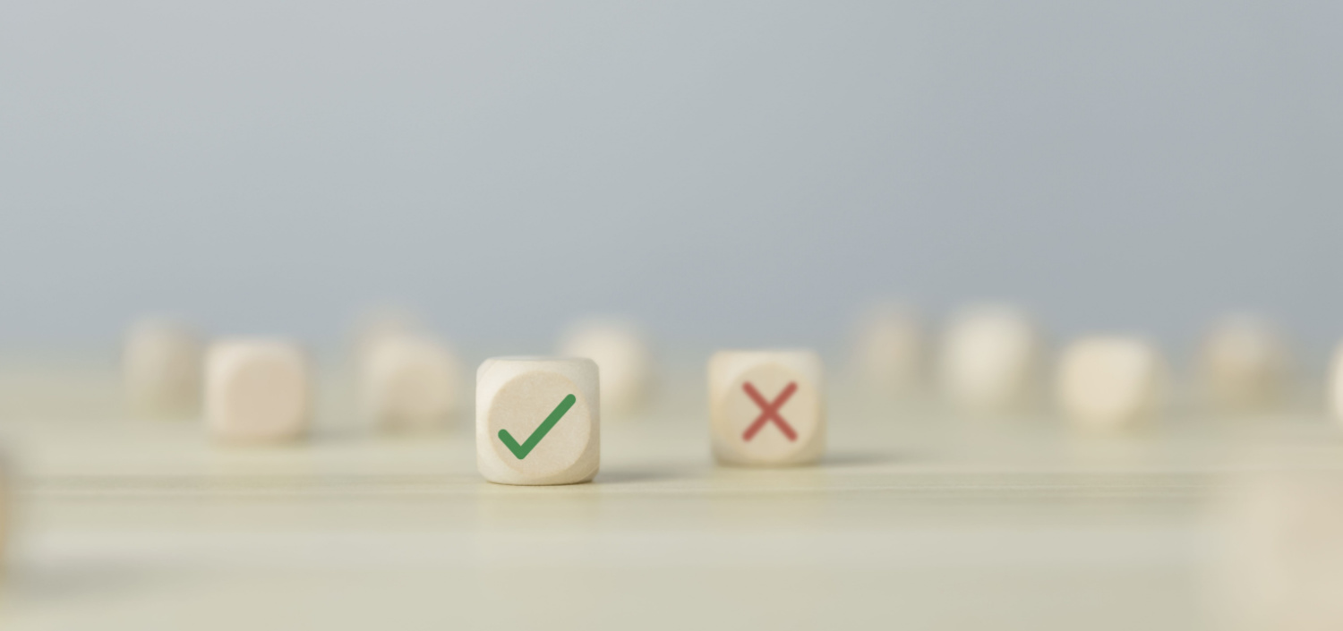 wood blocks with check mark and an x | employee background checks