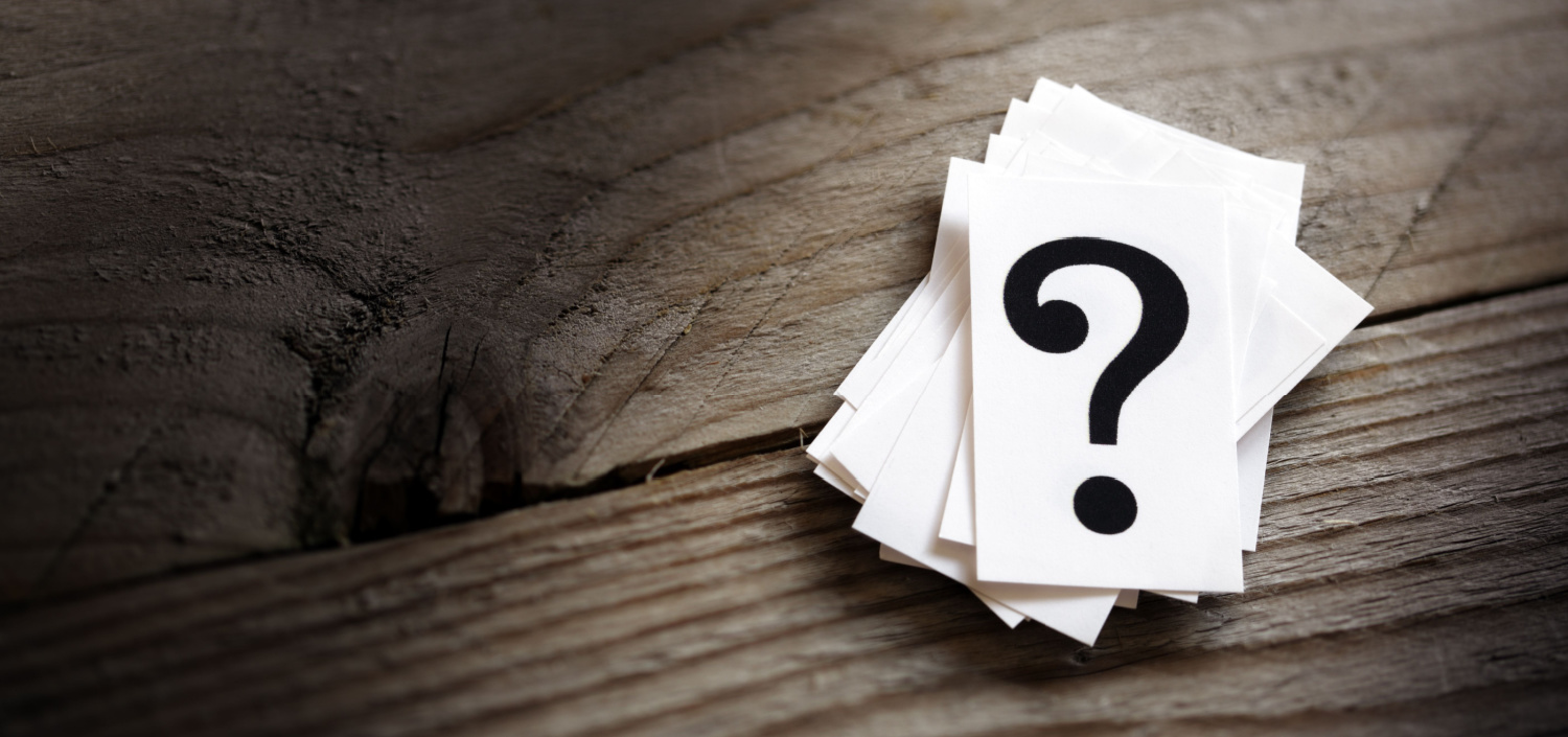 question mark on a wood tabletop | organizational change and PCI DS compliance