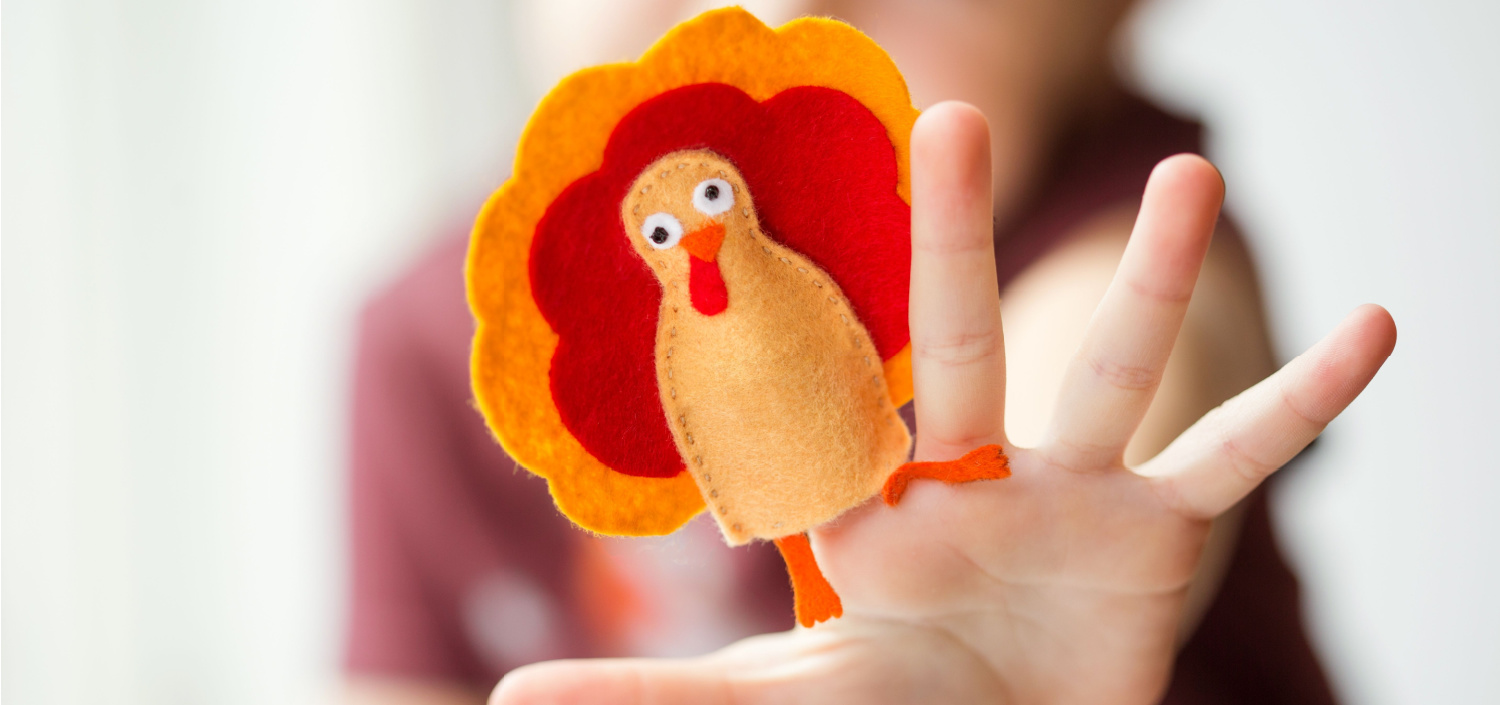 girl with a turkey finger puppet | TCT thanksgiving