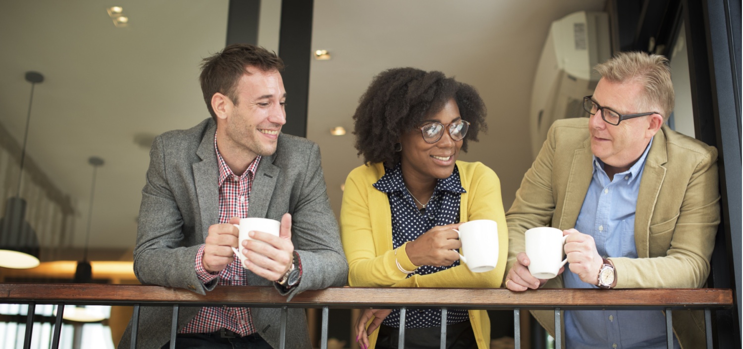 coworkers talking casually drinking coffee | Easier Compliance Management in a Change-Resistant Company