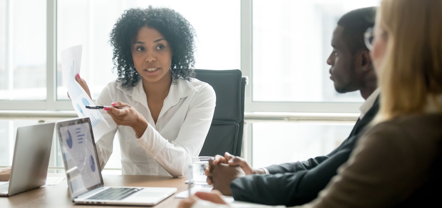 young woman conducting training and implementing a compliance management system with her team