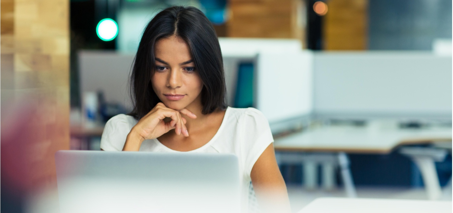 businesswoman at her laptop researching her company’s first compliance certification