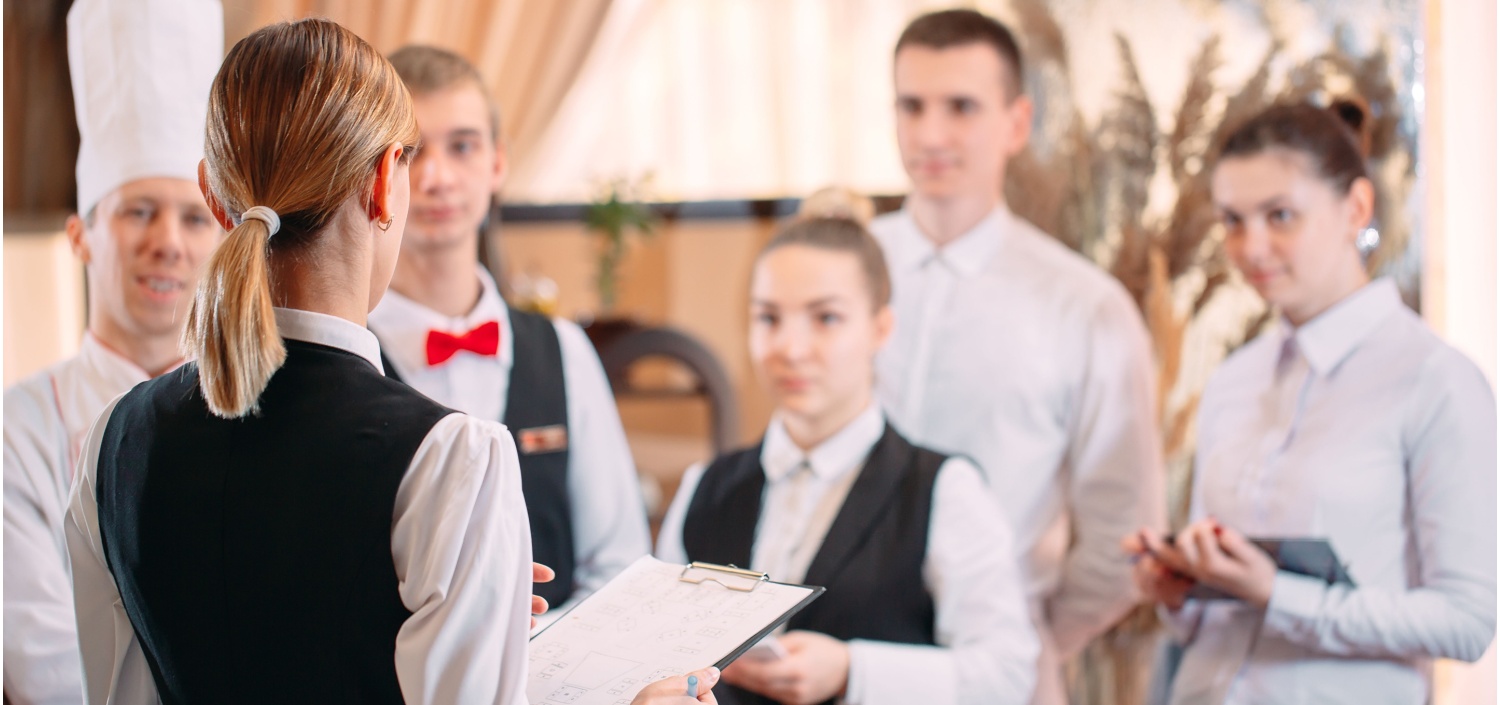 hotel manager overseeing staff | Managing Compliance in High Turnover Industries