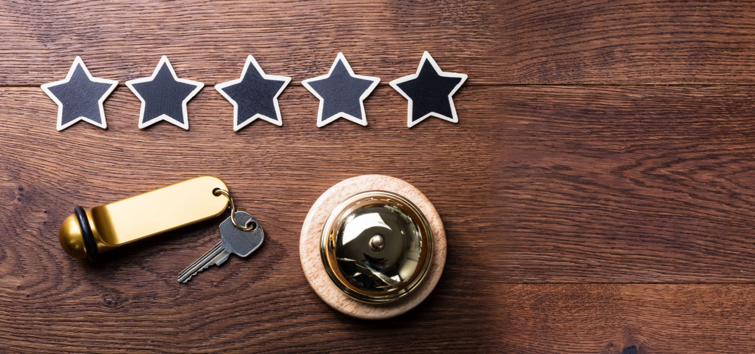 hotel check-in desk with 5 stars on it | TCT Portal Solves Hotels’ Most Complex Compliance Needs
