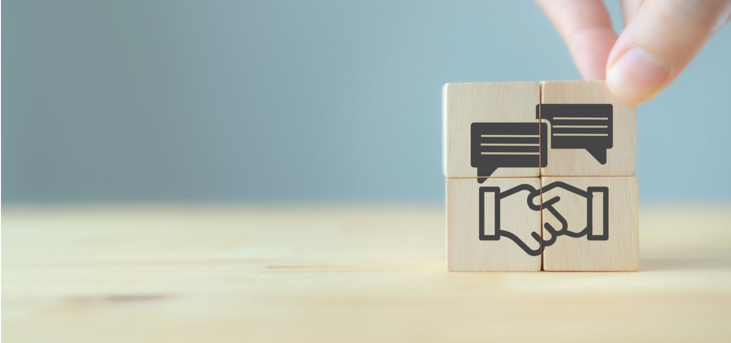 wood blocks with concept image of a merger and acquisition | Acquiring a Hotel Property? Compliance Due Diligence Could Save Your @$$.