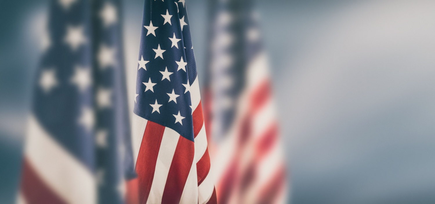 close-up photo of several American flags | A Salute to Compliance Professionals on Labor Day