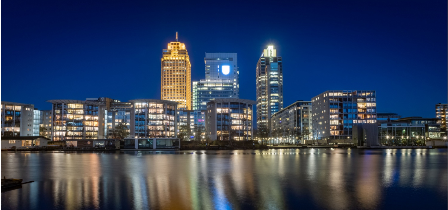 Skyline of Amsterdam at night, with Rembrandt Tower | PCI Europe Community Meeting