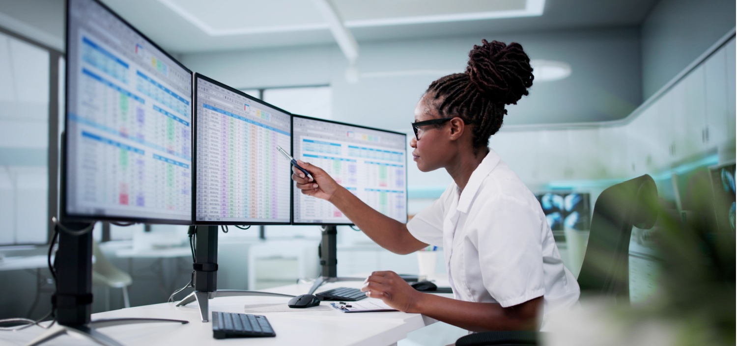 female nurse entering patient data into a hospital spreadsheet | HIPAA compliance