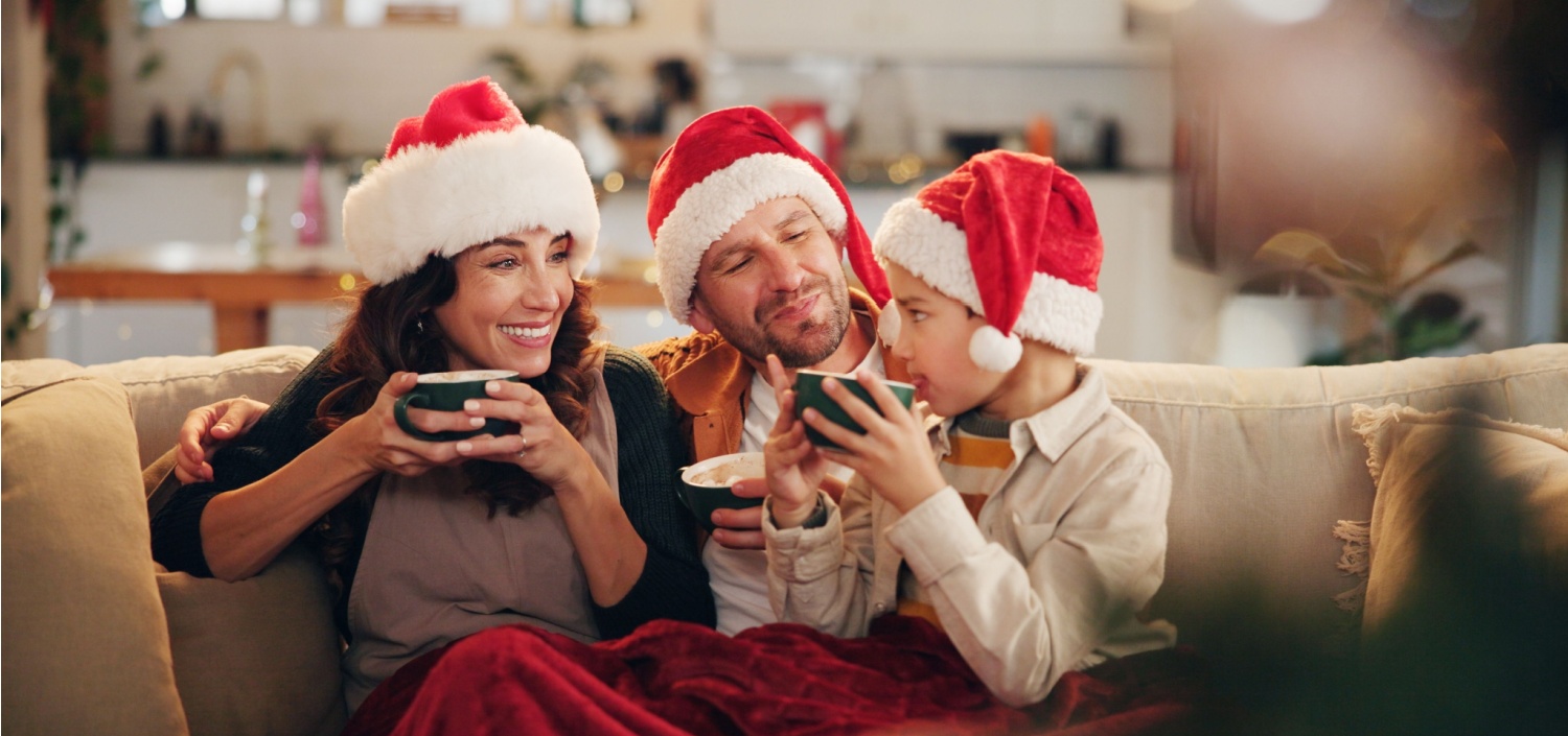 young family enjoying hot cocoa together at Christmas | Happy Holidays from All of Us at TCT