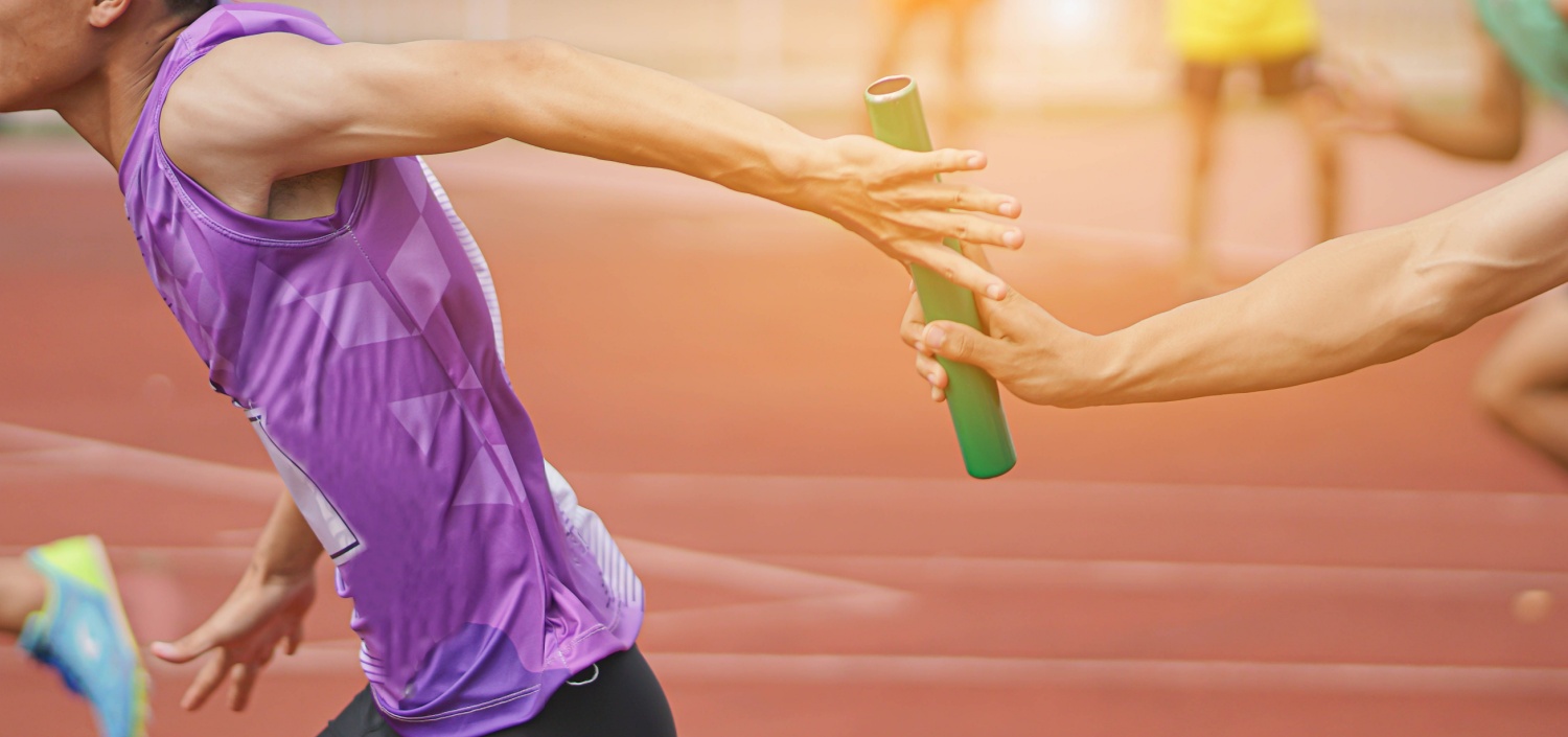 closeup of relay race runners passing the baton | help your compliance team truly excel