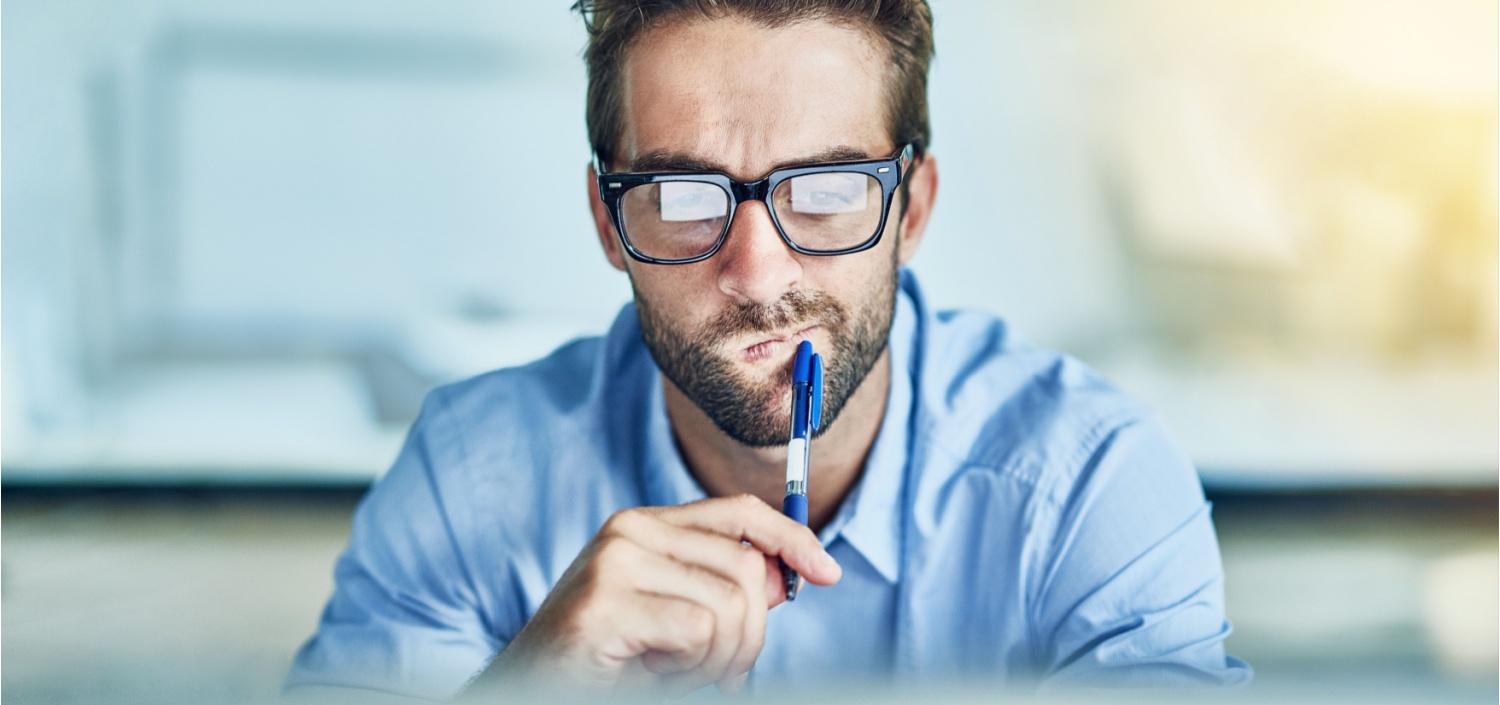 Businessman sitting in front of his laptop, thinking about AI security standard certification