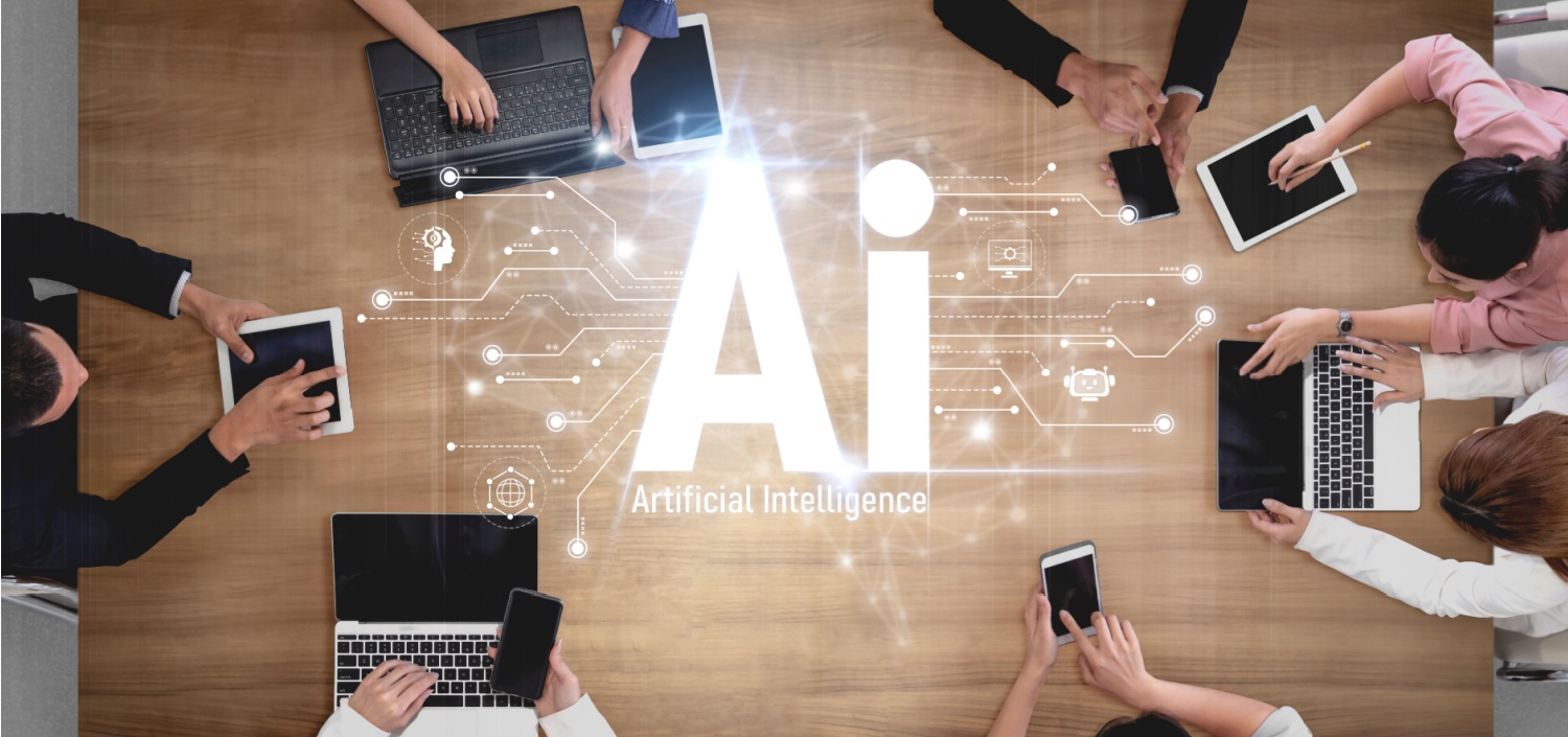 Employees gathered around a table with laptops, deploying AI agents securely