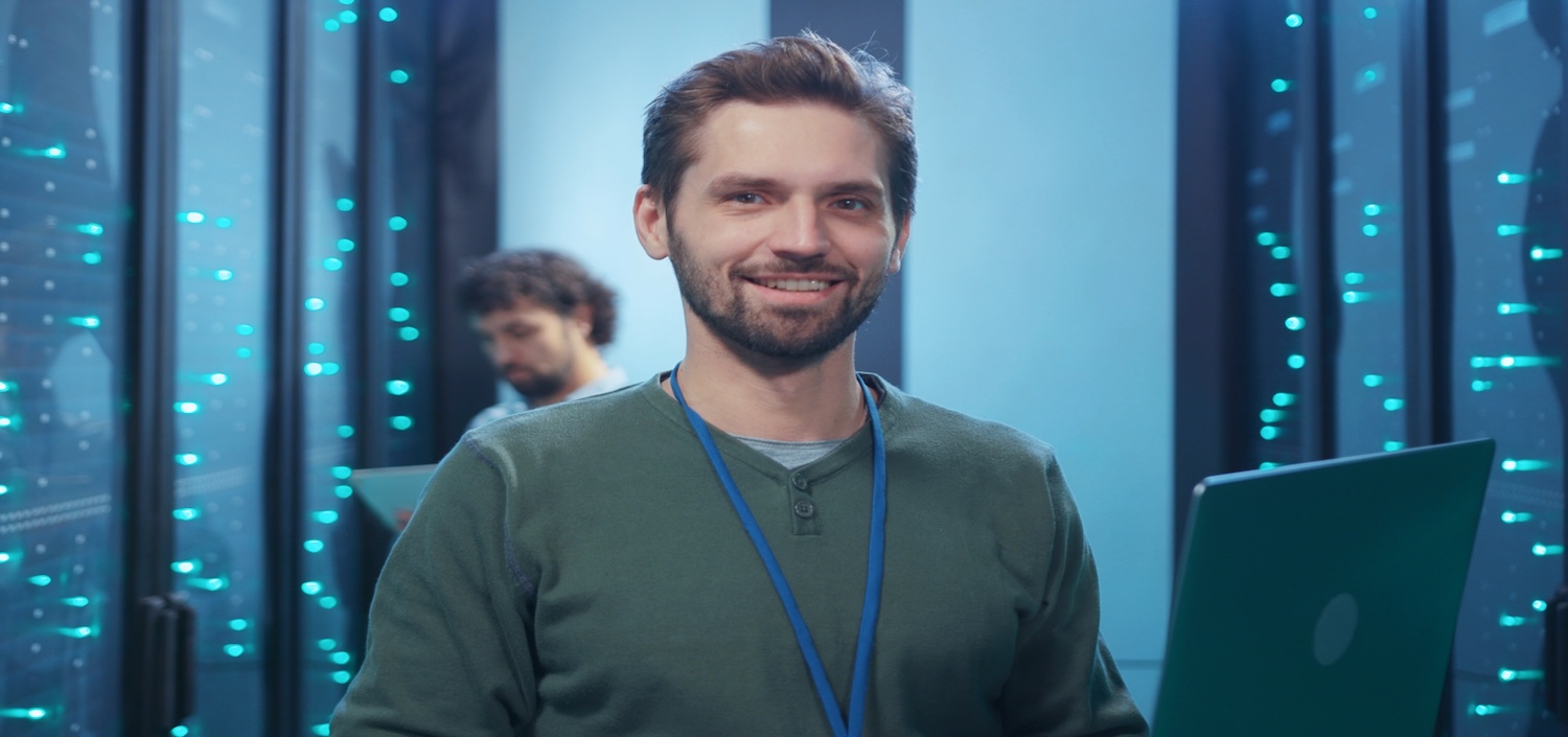 hosting service provider at a data center, smiling at the camera