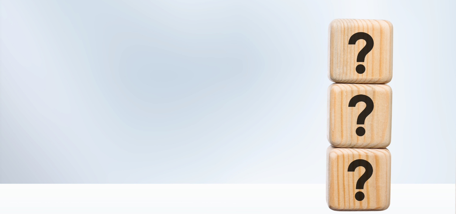 A stack of vertical wooden blocks with question marks on them | PCI DSS FAQs